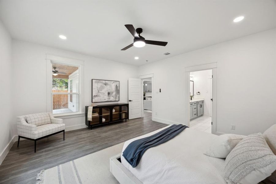 First floor primary bedroom with recessed lighting and a ceiling fan