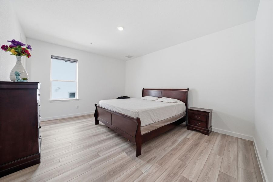 This room features light-toned flooring, white walls, and a window providing natural illumination