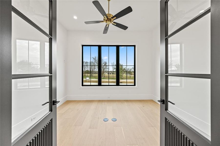 Light wood-finish flooring with floor-mounted electrical outlets
