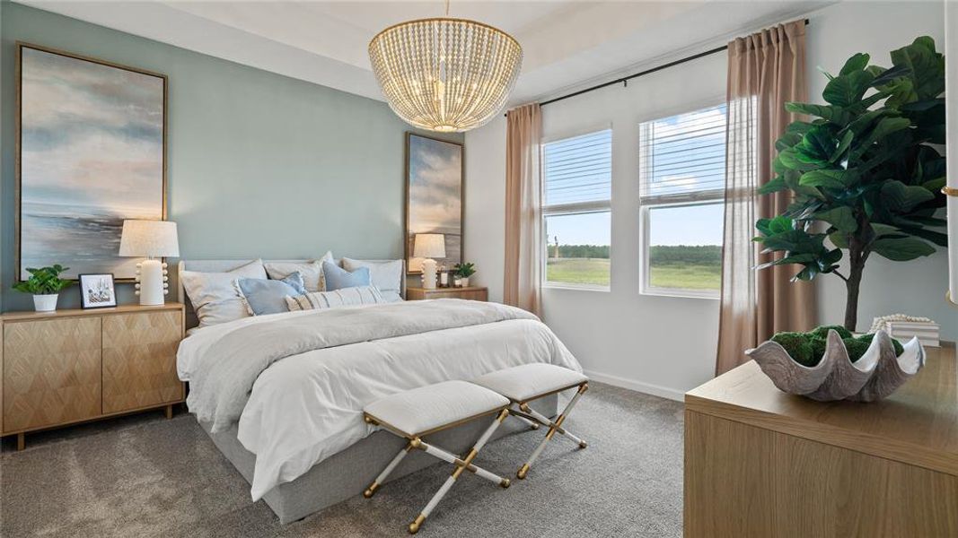 Carpeted bedroom featuring a chandelier and baseboards Carpeted bedroom featuring a chandelier and baseboards