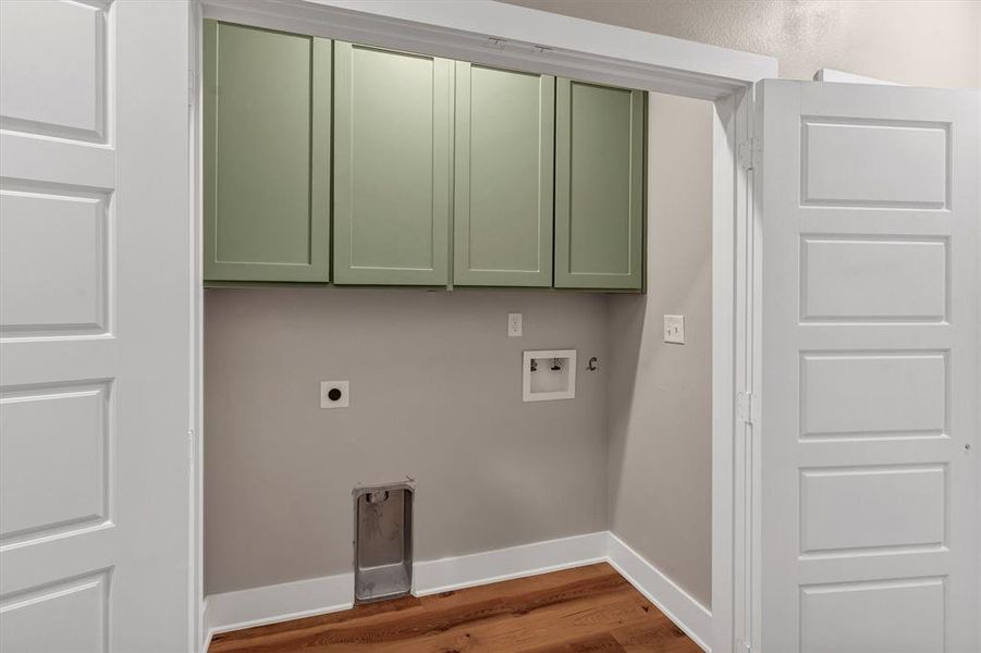 Laundry area with cabinet space, wood finished floors, hookup for an electric dryer, and washer hookup Laundry area with cabinet space, wood finished floors, hookup for an electric dryer, and washer hookup