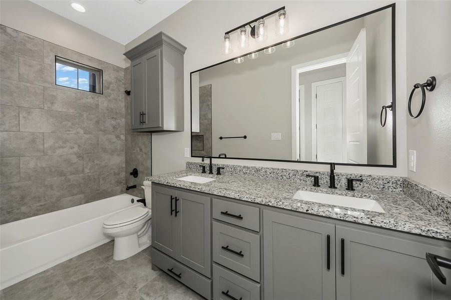 Full bathroom featuring double vanity and  shower combination