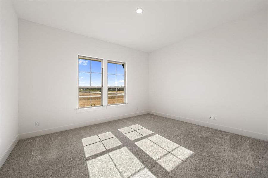Carpeted empty room with baseboards and recessed lighting