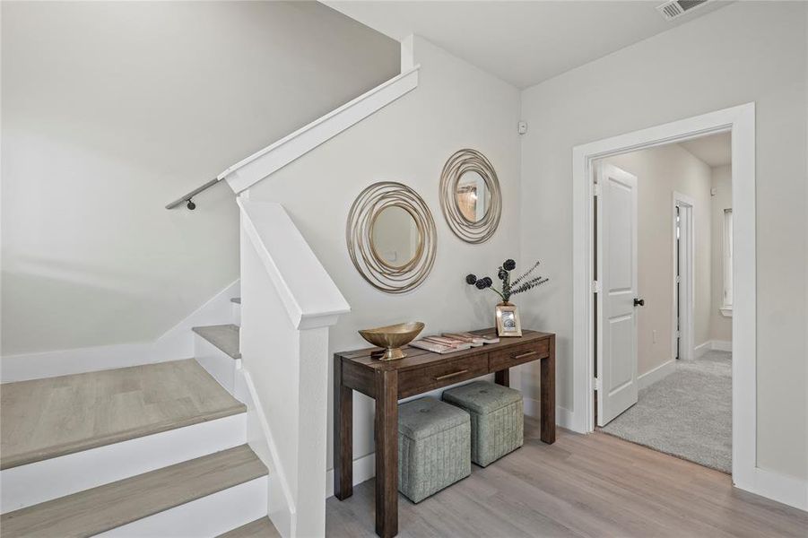 Staircase with wood finished floors and baseboards