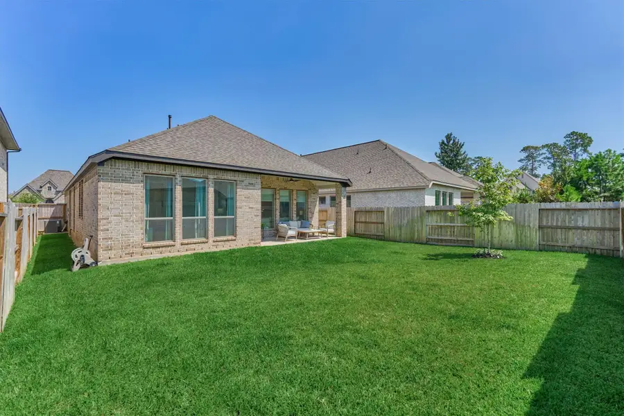 Enjoy the large green space in the fenced backyard and white oak tree.