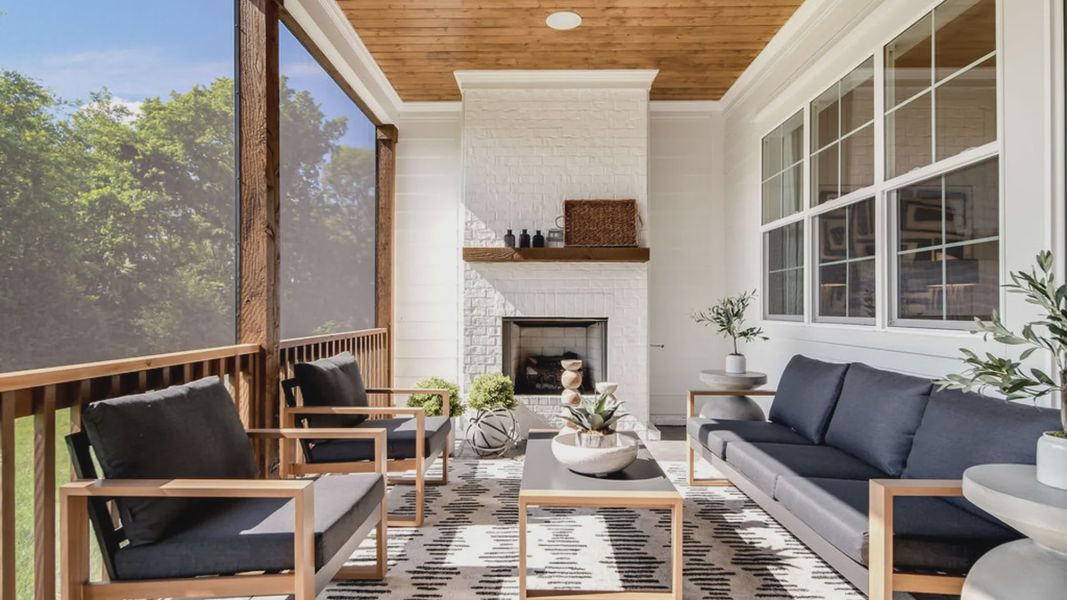 Screened-in backyard porch with outdoor living space.