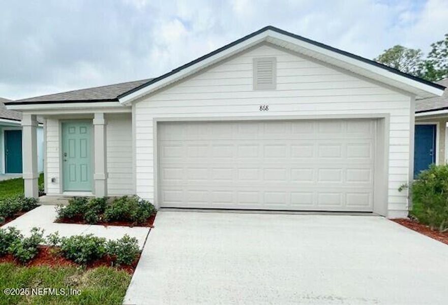 Front exterior of a new home in Grand Reserve, Bunnell, FL, highlighting curb appeal (Image 27).
