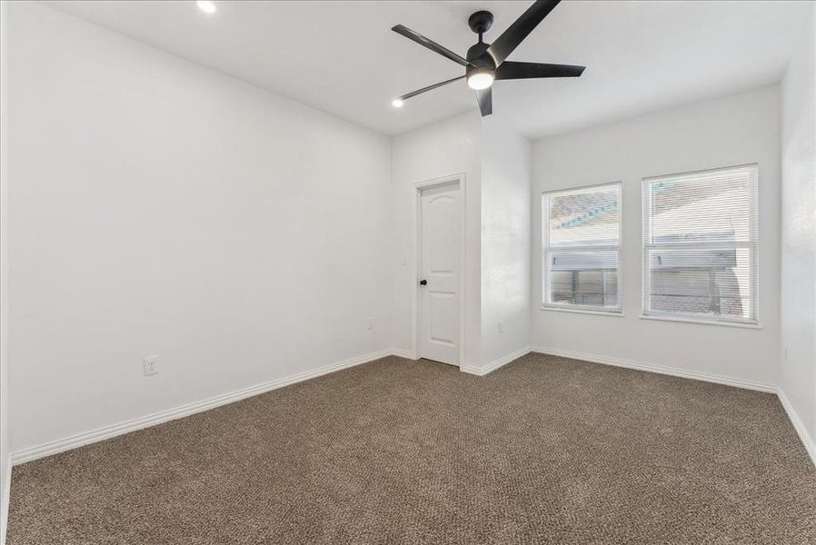 Unfurnished room with a ceiling fan, dark colored carpet, baseboards, and recessed lighting