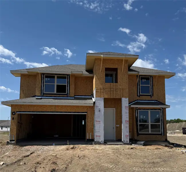 View of front facade with dirt driveway, stucco siding, and an attached garage View of front facade with dirt driveway, stucco siding, and an attached garage