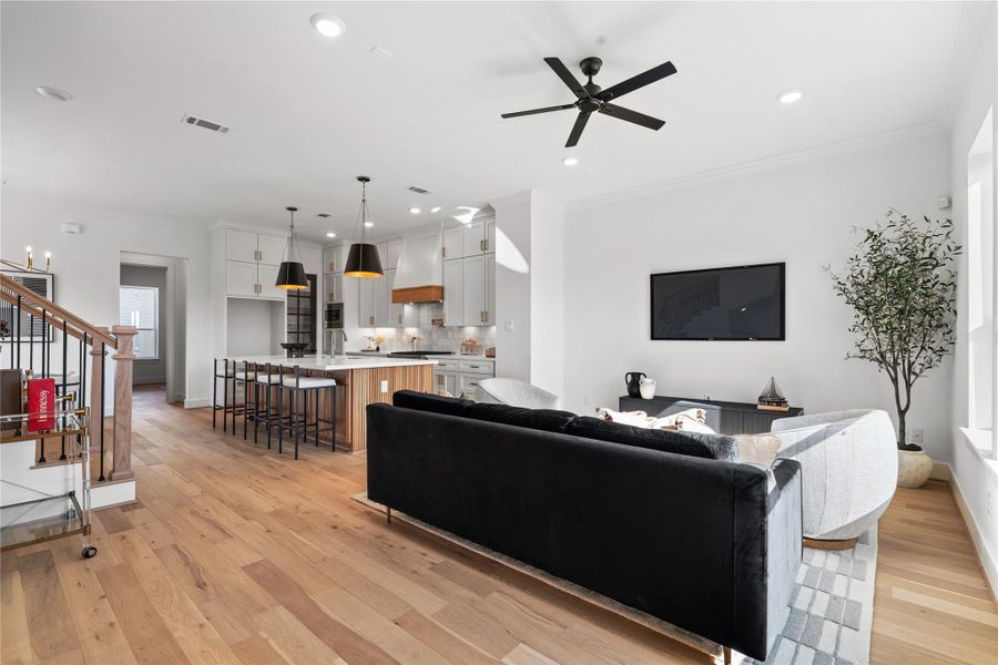 A beautifully appointed living and kitchen area with luxury finishes, custom kitchen cabinetry, and a chef’s kitchen designed to impress while offering effortless functionality.