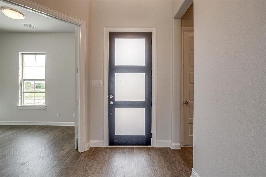 Entrance foyer with wood-type flooring