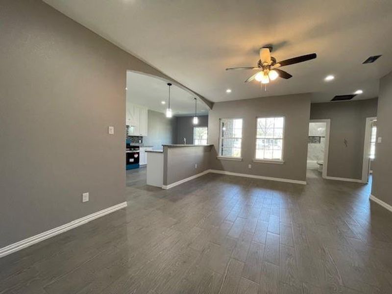 Entering living room with ceiling fan, baseboards, and ceramic wood-style flooring Entering living room with ceiling fan, baseboards, and ceramic wood-style flooring