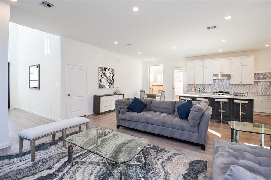 This open, amazing living area shares generous space with a full contemporary kitchen.