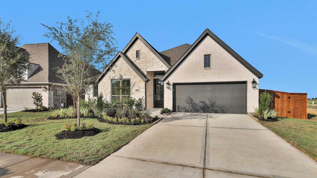 Front exterior of a new home in Serenity 55+ Active Adult, Arcola, TX, highlighting curb appeal (Image 1).