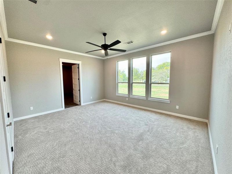 Carpeted empty room featuring ornamental molding, ceiling fan, baseboards, and recessed lighting