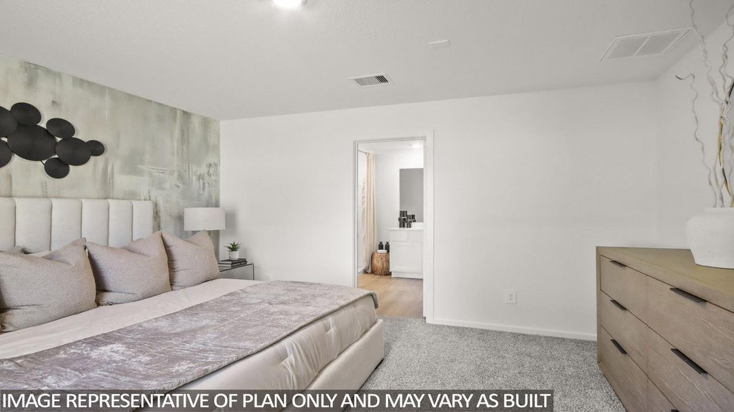 Bedroom featuring an accent wall and light carpet