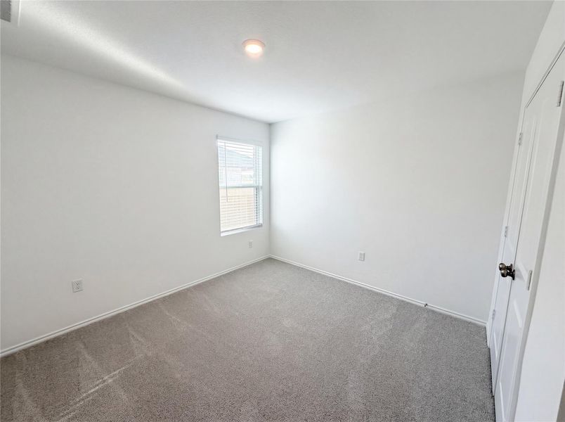 Unfurnished bedroom with a closet and carpet floors