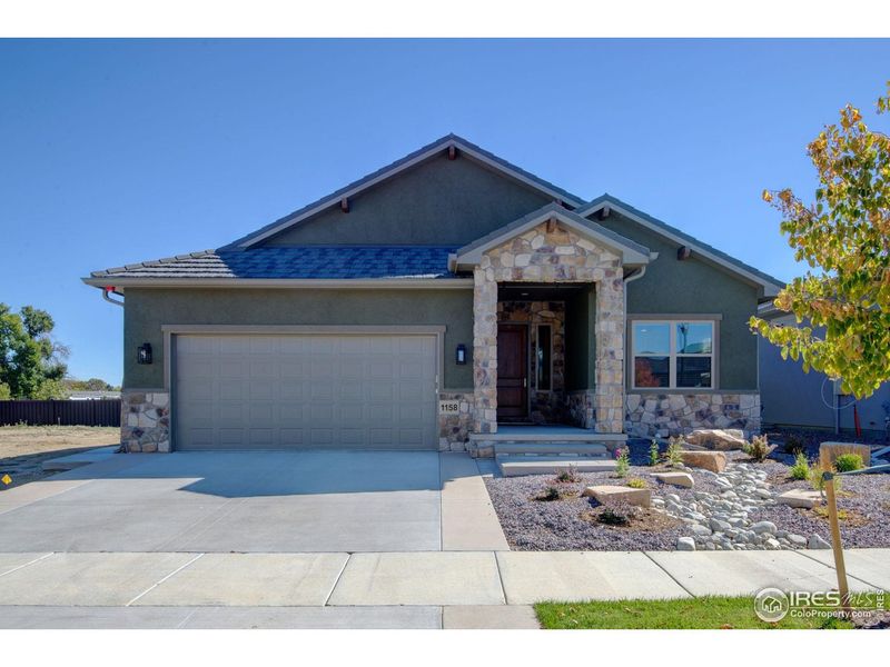 Front exterior of a new home in , Loveland, CO, highlighting curb appeal (Image 26).