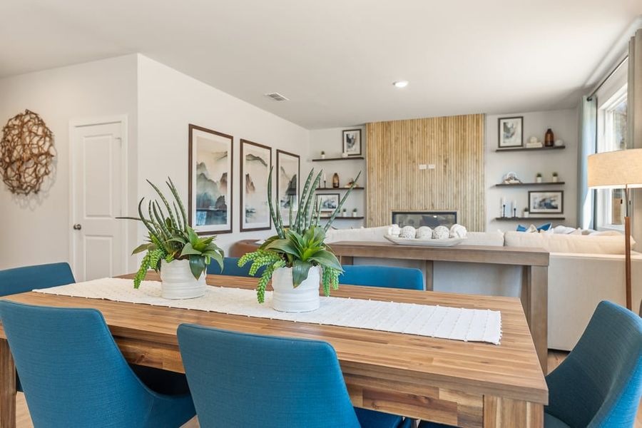 A dining room table with blue chairs. A dining room table with blue chairs.