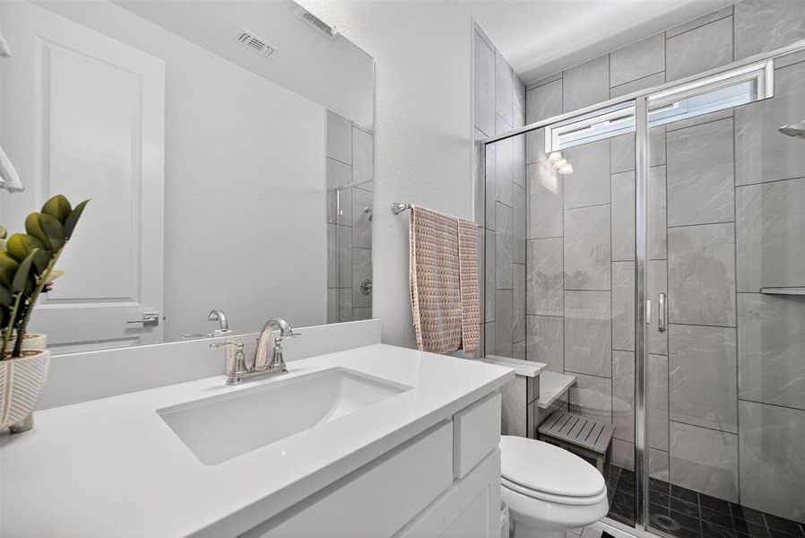 Bathroom with a shower stall and vanity Bathroom with a shower stall and vanity