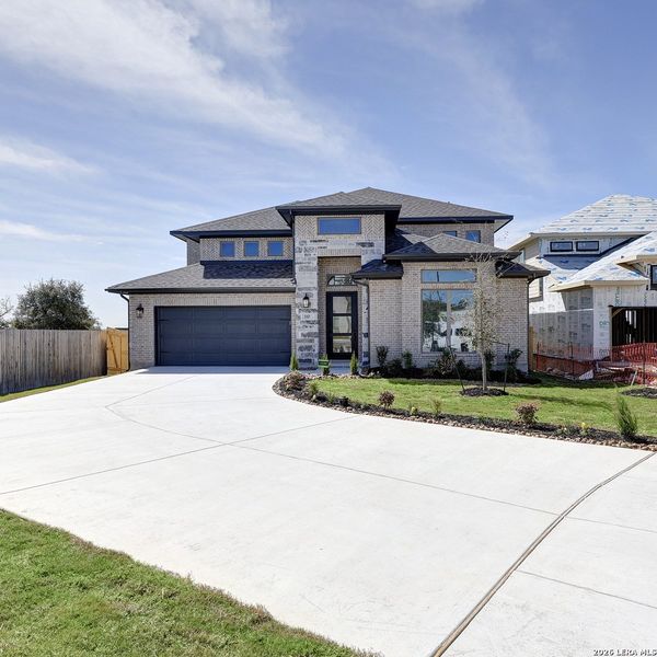 Front exterior of a new home in The Ranches at Creekside, Boerne, TX, highlighting curb appeal (Image 2).