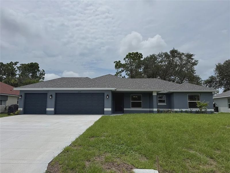 Front exterior of a new home in North Port, North Port, FL, highlighting curb appeal (Image 1). Front exterior of a new home in North Port, North Port, FL, highlighting curb appeal (Image 1).