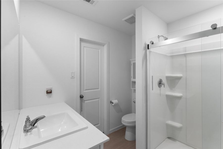 Private en-suite bathroom offers convenience just steps from the primary bedroom.