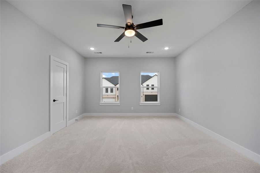 Unfurnished room featuring recessed lighting, visible vents, light colored carpet, and baseboards