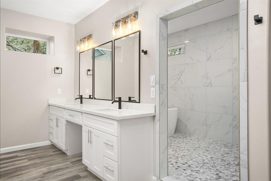 Primary bedroom with double vanity and oversized shower room