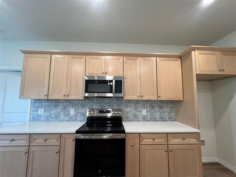 Kitchen with stainless steel appliances, Electric Range & Microwave & pull out spice rack