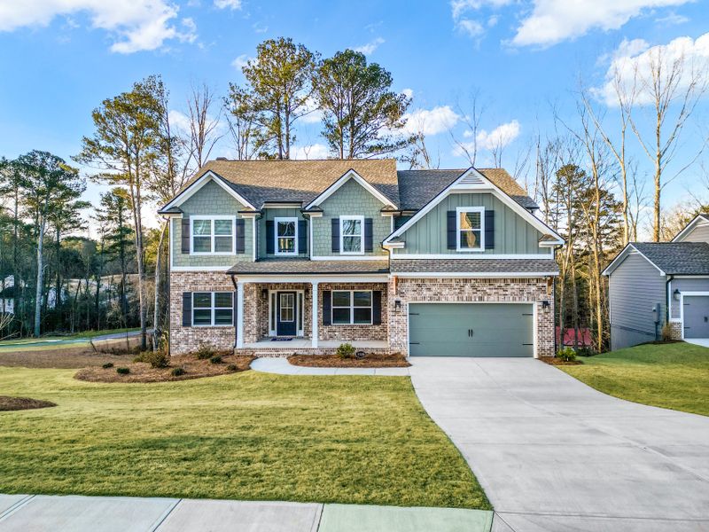 Front exterior of a new home in Woodland Hills, Loganville, GA, highlighting curb appeal (Image 1). Front exterior of a new home in Woodland Hills, Loganville, GA, highlighting curb appeal (Image 1).