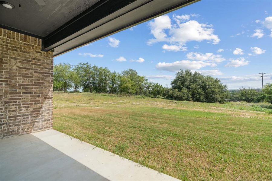 Kitchen featuring open floor plan, premium range hood, a ceiling fan, white cabinets, and light countertops