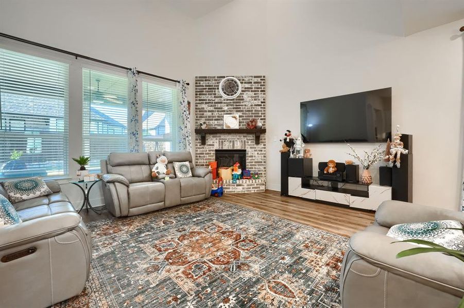 Living room featuring hardwood / wood-style flooring, plenty of natural light, and a fireplace