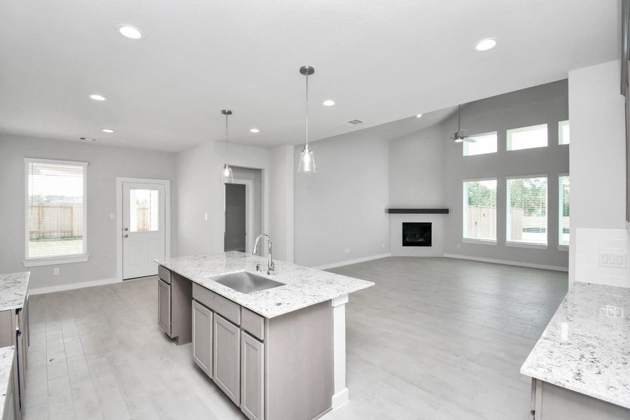 All of this overlooks your expansive family room, creating a perfect space for culinary delights and family gatherings. Sample photo of completed home with similar floor plan. Actual colors and selections may vary. All of this overlooks your expansive family room, creating a perfect space for culinary delights and family gatherings. Sample photo of completed home with similar floor plan. Actual colors and selections may vary.