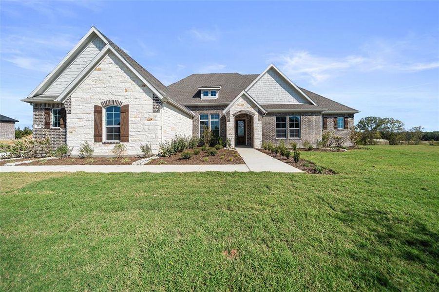 View of front of property with a front lawn, stone siding, and a shingled roof View of front of property with a front lawn, stone siding, and a shingled roof