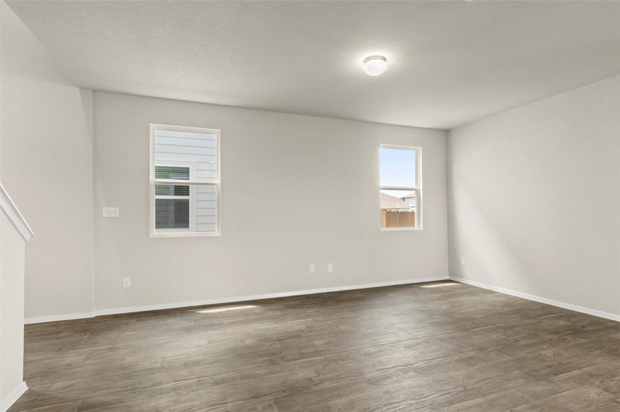 Spare room with dark wood finished floors