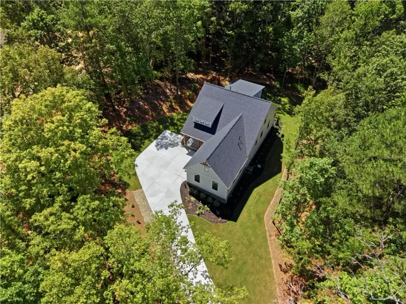 Mature woodlands envelope this modern home, offeri