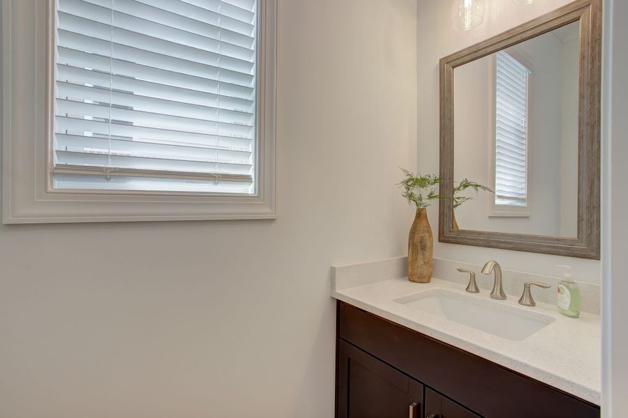 Powder room located on the main level off the kitchen