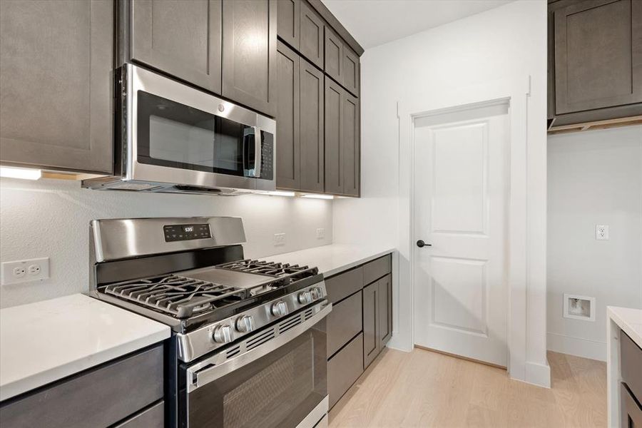 Beautiful cabinetry paired with stainless appliances and quartz countertops make this kitchen a dream come true!