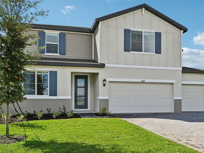 Front exterior of a new home in Oakfield Trails - Premier Series, Parrish, FL, highlighting curb appeal (Image 1).