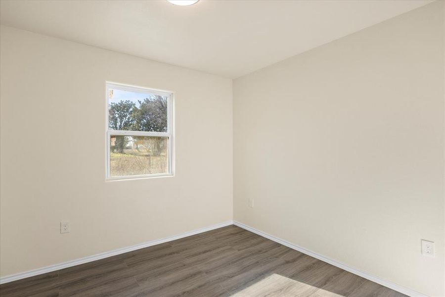 Unfurnished room with dark hardwood / wood-style flooring