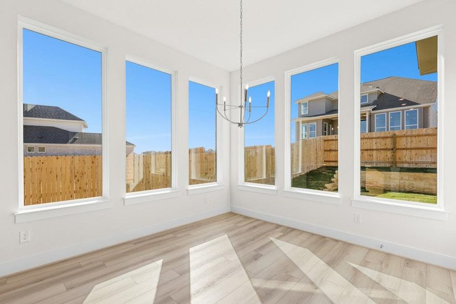 Unfurnished sunroom with a chandelier and wood finished floors Unfurnished sunroom with a chandelier and wood finished floors