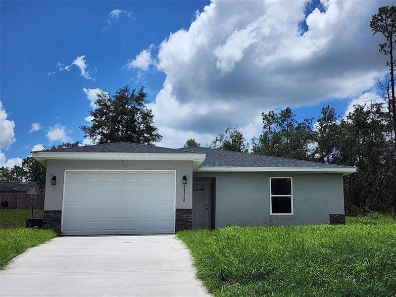 Front exterior of a new home in , Dunnellon, FL, highlighting curb appeal (Image 1).