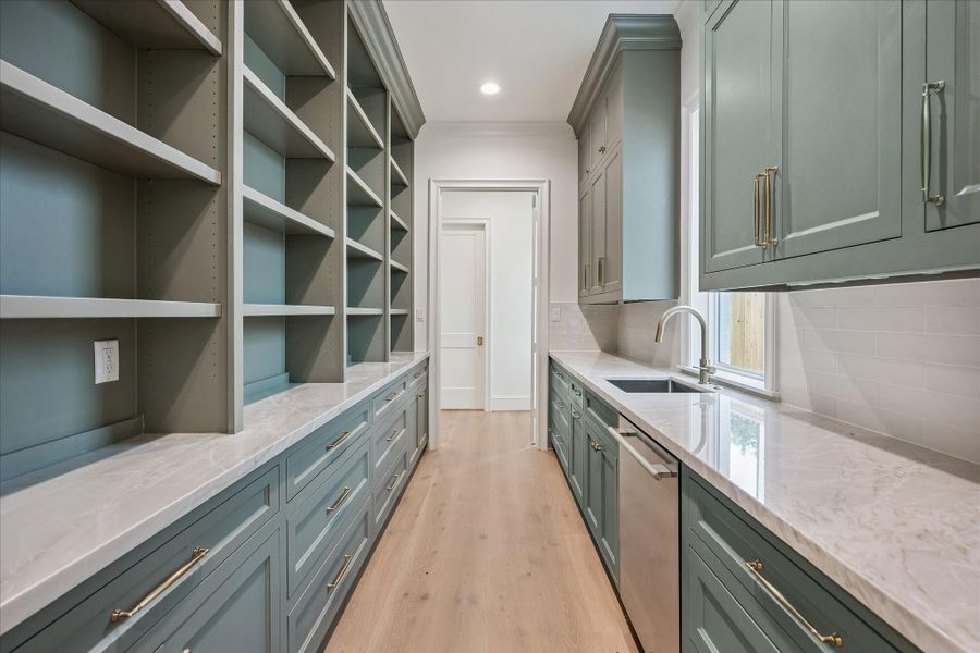 Scullery behind main kitchen features full sink and dishwasher