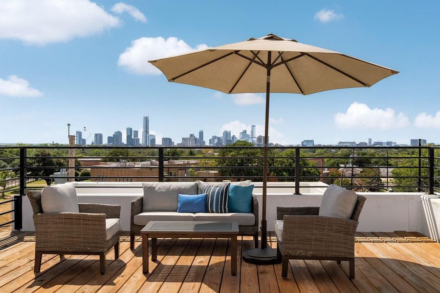 Deck featuring outdoor lounge area and a skyline view