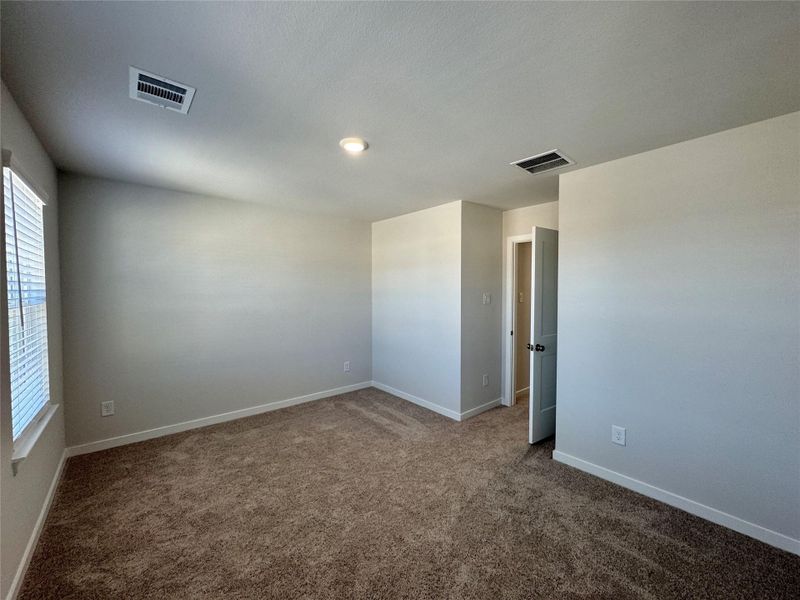 Large upstairs bedroom facing the front of the home with a walk-in closet. Large upstairs bedroom facing the front of the home with a walk-in closet.