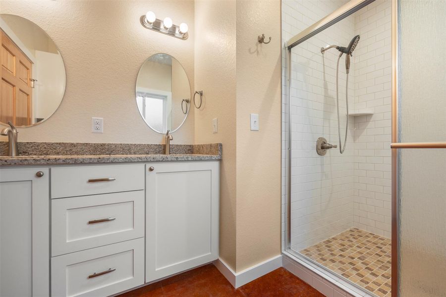 Full bath with a stall shower, double vanity