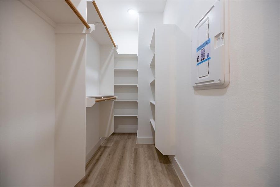 The closet provides ample double-hanging space, featuring two built-in shoe storage racks and additional long-hanging space for added convenience.