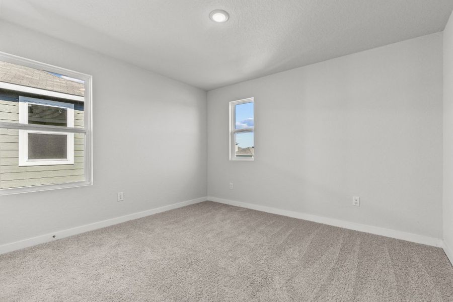 A room with a carpet and windows. A room with a carpet and windows.