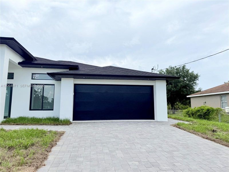Front exterior of a new home in , Lehigh Acres, FL, highlighting curb appeal (Image 22).